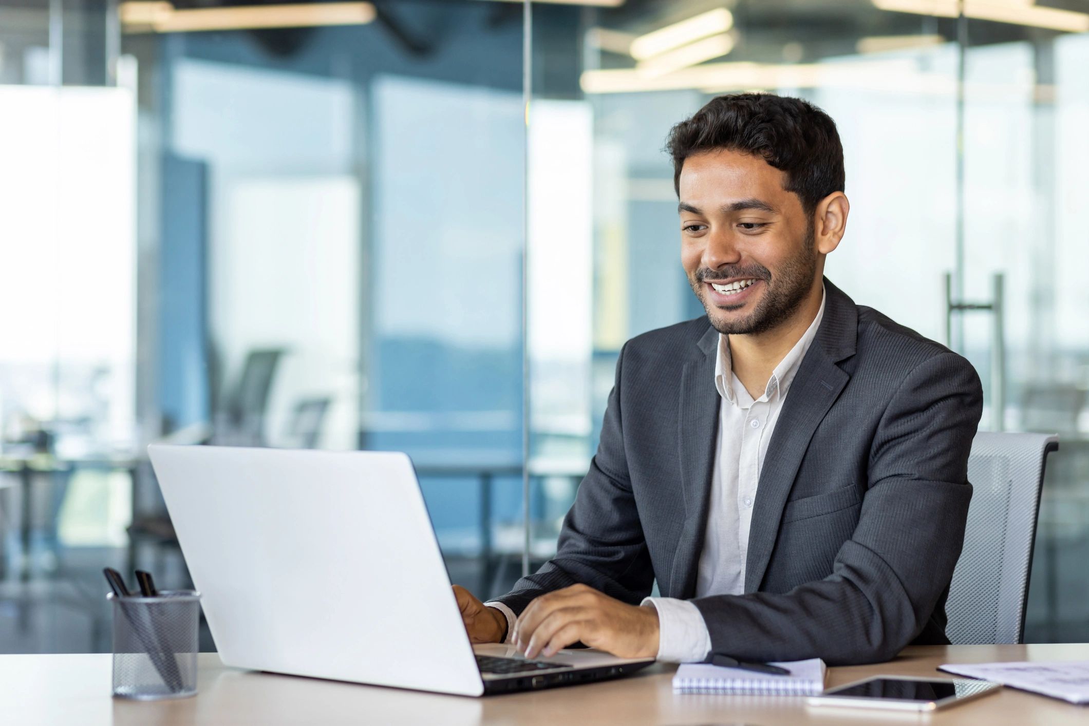 Professional working on a laptop in an office