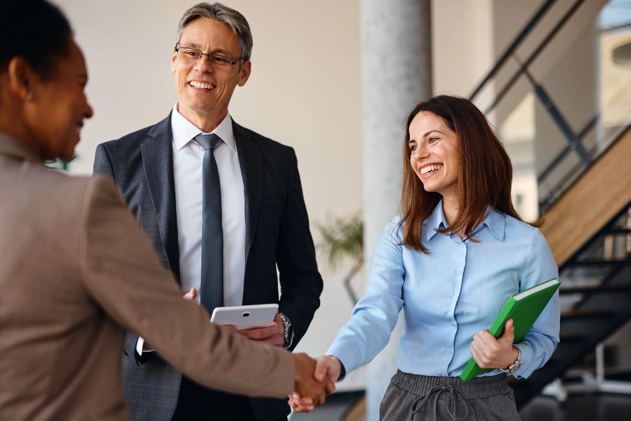 Business partners shaking hands in an office meeting